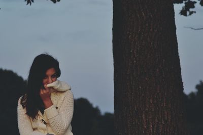 Close-up of woman standing against sky