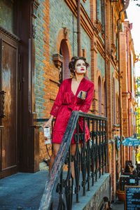 Full length portrait of woman standing in city