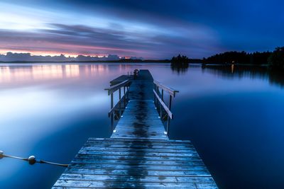 Jetty over lake against sky during sunset