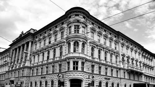 Low angle view of building against cloudy sky