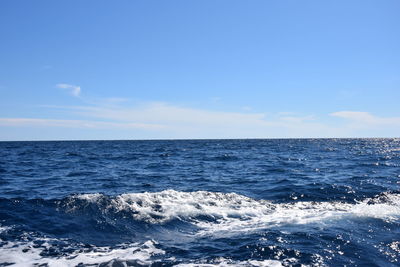 Scenic view of sea against blue sky