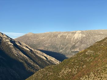 Scenic view of mountains against clear blue sky