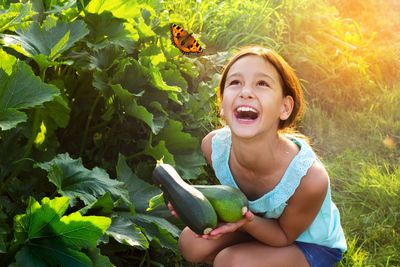 Portrait of smiling girl sitting outdoors