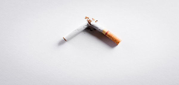 High angle view of cigarette against white background