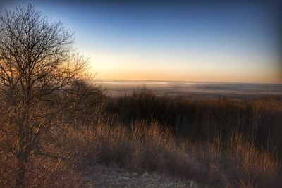 Scenic view of sea against clear sky during sunset