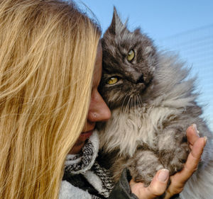 Portrait of woman holding cat