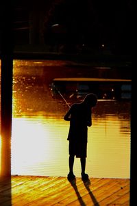 Full length of child standing on illuminated floor