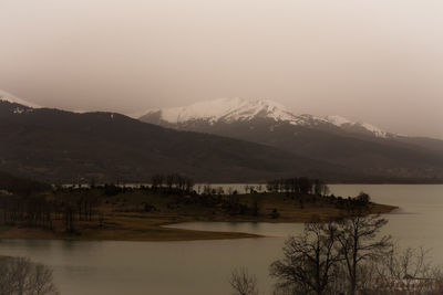 Scenic view of lake against sky at sunset