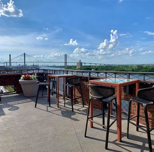 Empty chairs and tables in restaurant against sea