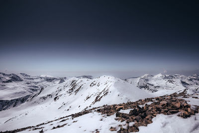 Scenic view of snow covered mountains against sky