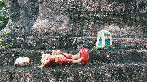 Toys on rock against wall