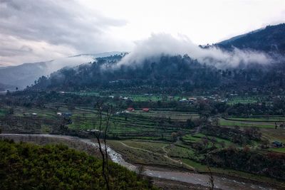 Scenic view of river and mountains against sky