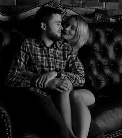 Young couple sitting outdoors