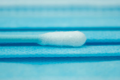 Close-up of ice on table against blue background