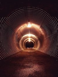 Illuminated tunnel at night