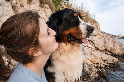 Close-up of woman with dog at beach