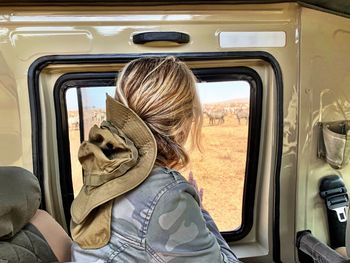 Portrait of woman seen through car window