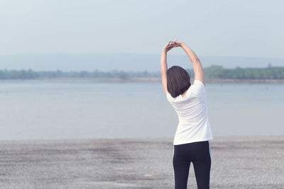 Rear view of woman standing in water