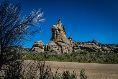 Rock formations against clear blue sky