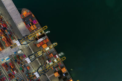 High angle view of illuminated buildings against sky at night