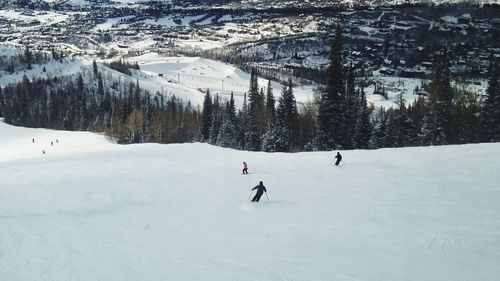 People skiing on snow covered landscape