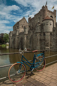 Bridge and bike in front of gravensteen castle in ghent. a city full of gothic buildings in belgium.