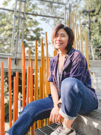 Portrait of smiling woman sitting outdoors