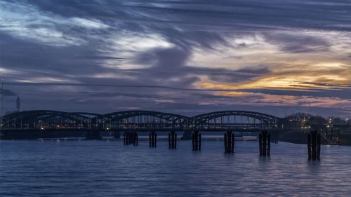 Bridge over river at sunset