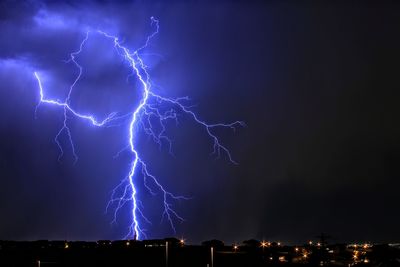 Low angle view of lightning in sky at night