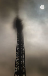 Low angle view of illuminated building against cloudy sky