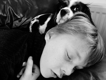 Close-up of sleeping boy and a dog