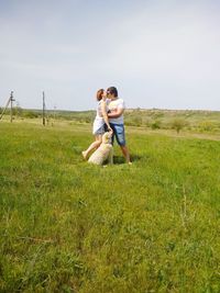 Full length of happy couple walking on field