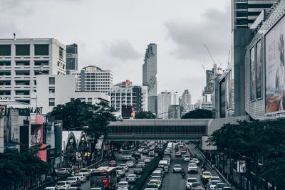 View of city street and modern buildings against sky