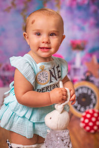 Portrait of cute baby girl holding stuffed toy rabbit