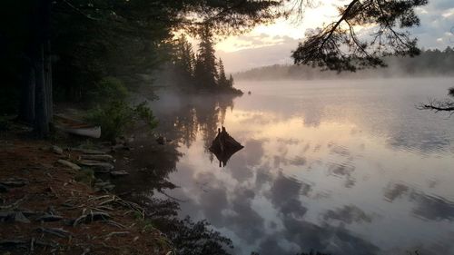 Scenic view of lake against sky at sunset