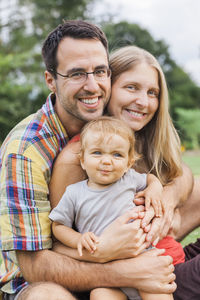 Portrait of happy family sitting outdoors