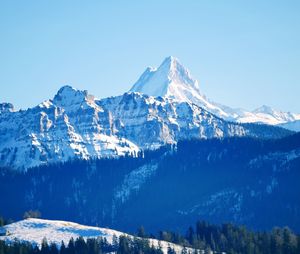 Scenic view of snowcapped mountains against clear sky