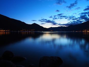 Scenic view of lake against sky at night