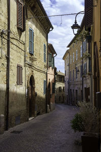 Street amidst buildings in city against sky