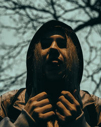 Close-up portrait of man wearing cape