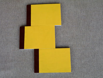 High angle view of yellow paper on table