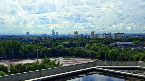 Buildings in city against cloudy sky