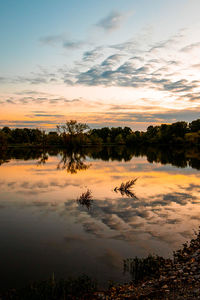 Scenic view of lake against sky during sunrise 