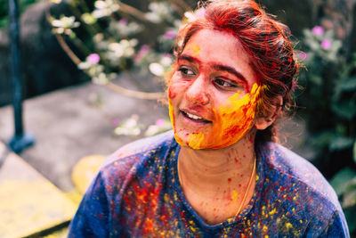 Young woman with powder paint on face during holi