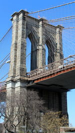 Low angle view of bridge against blue sky