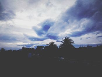 Silhouette trees on landscape against sky