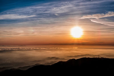 Scenic view of silhouette mountains against sky during sunset