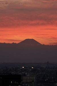 Aerial view of townscape against sky during sunset