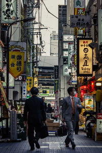 People standing on road in city