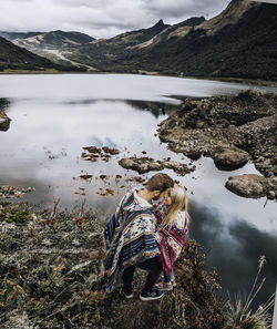 High angle view of couple standing by lake